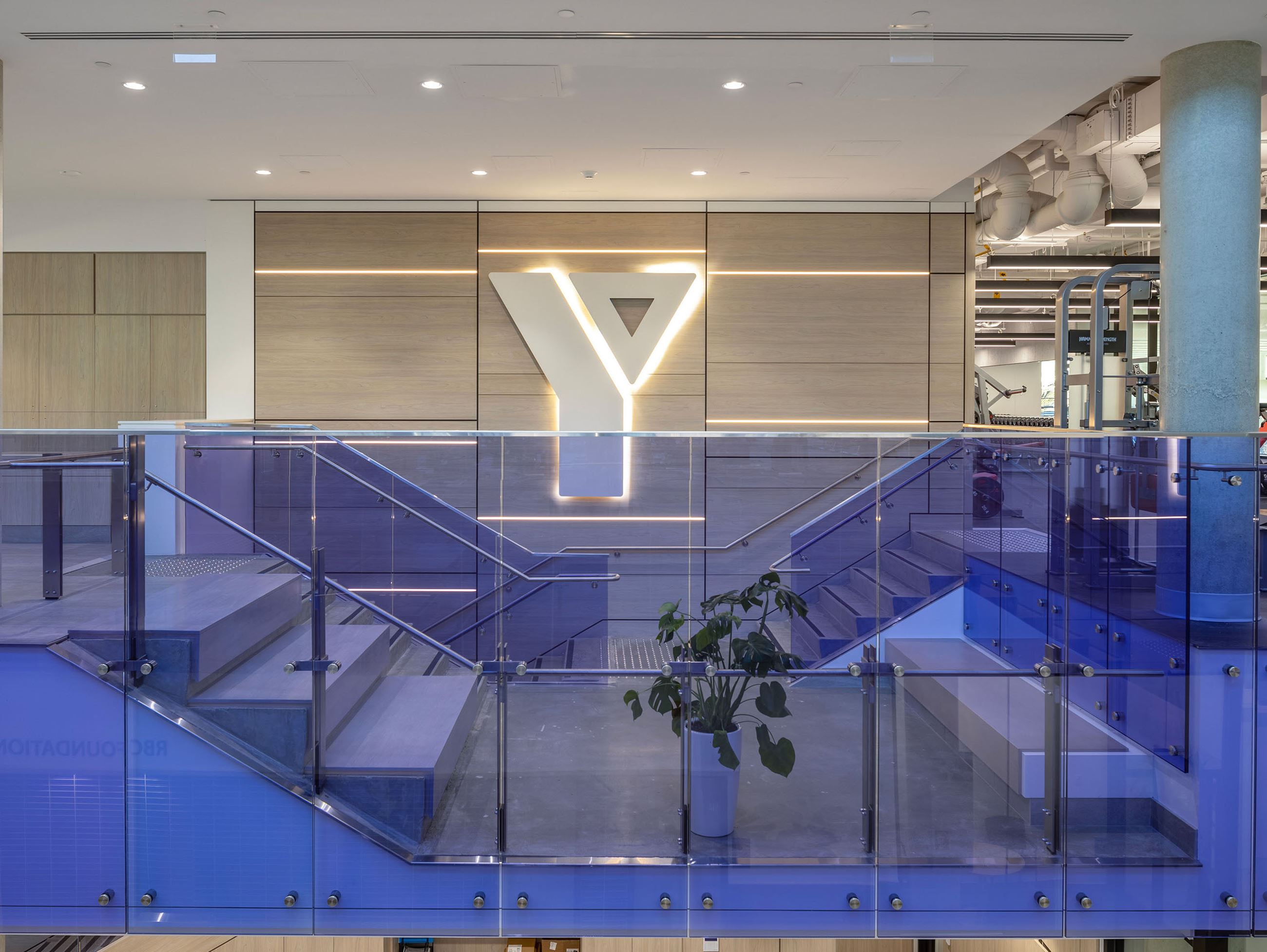 The main staircase in the Bettie Allard YMCA with the Y logo showing on the wall