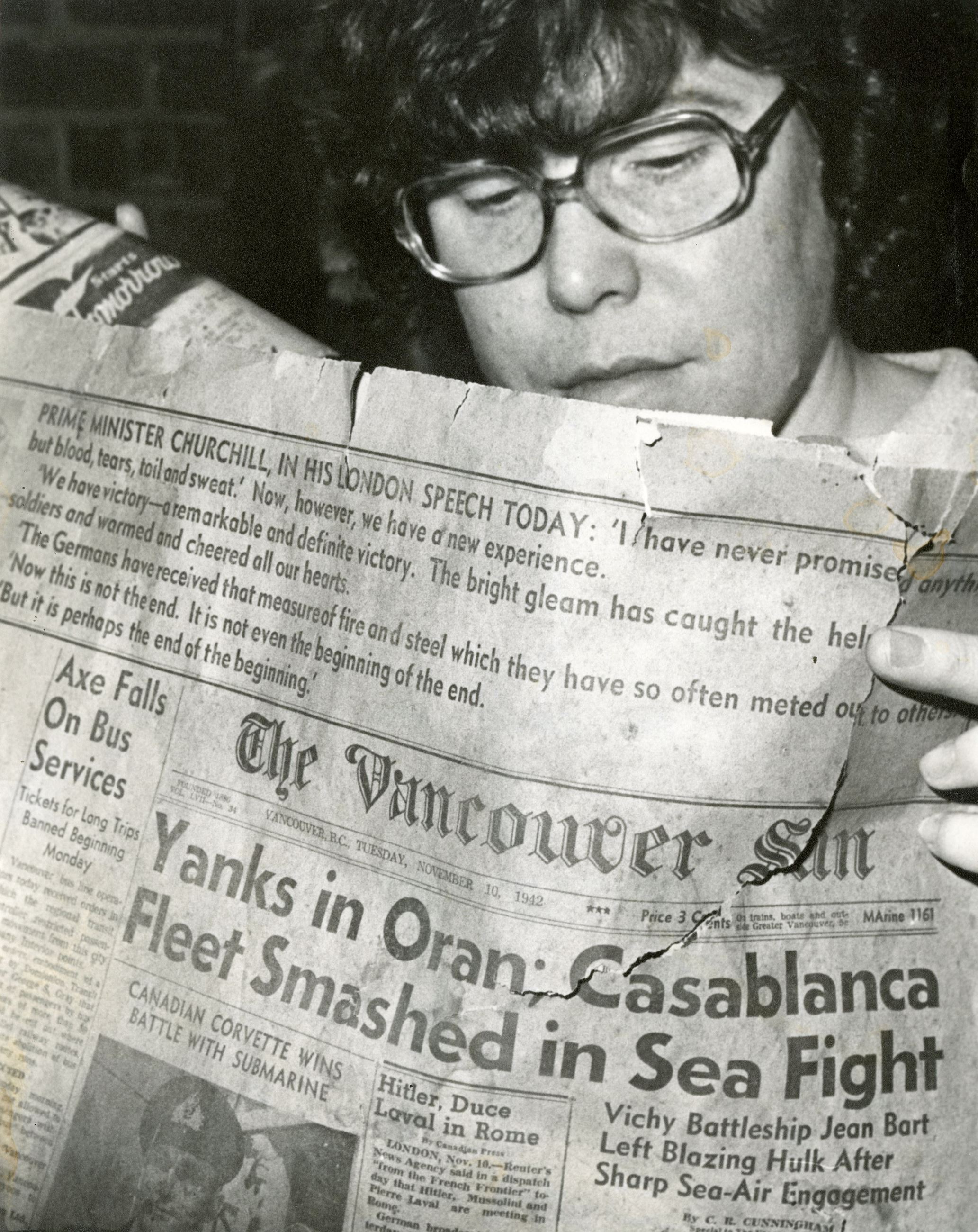 Marion MacKenzie reading an issue of the Vancouver Sun from 1942, 1979