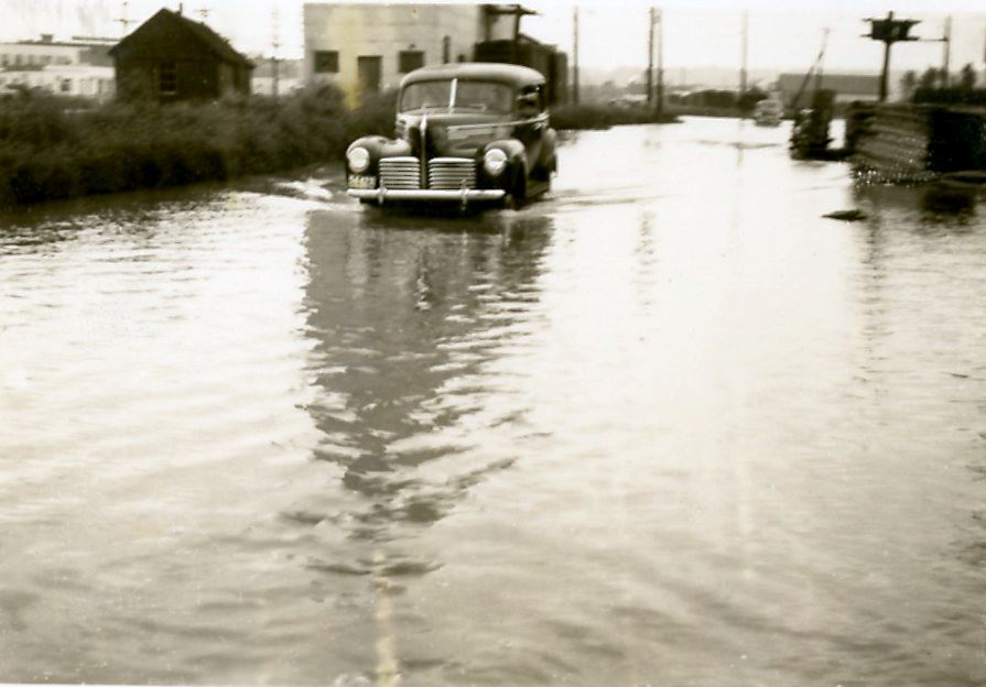 Car drives through the water at Fraser Mills, 1948 (Source City of Coquitlam Archives, MH.2005.28.1c Opens in new window