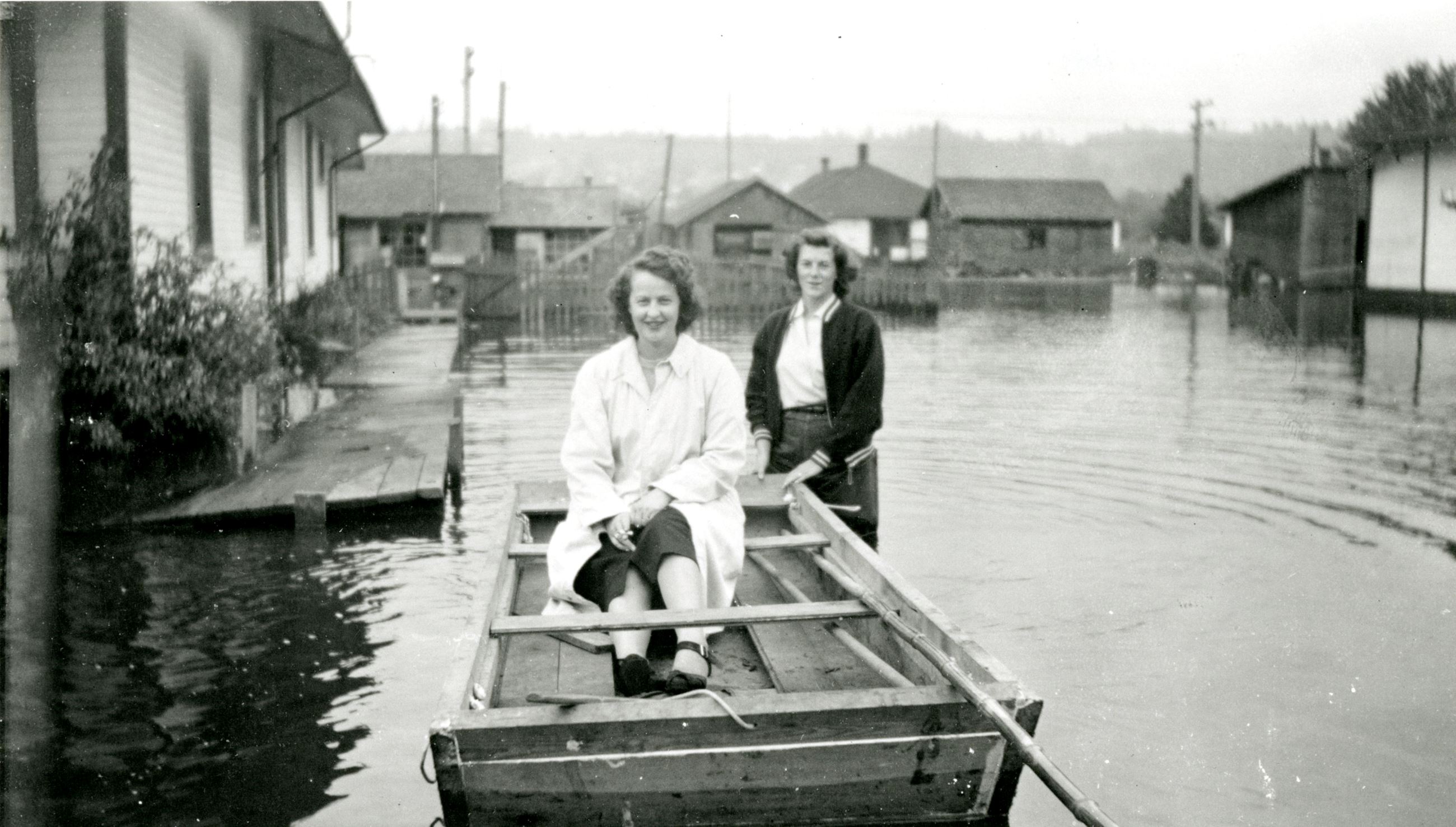 Kay Martin and Rosa Marie Crandell in a makeshift boat during the 1948 flood (Source City of Coquitl Opens in new window